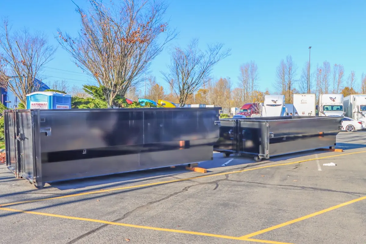 Professional dumpster rental service with roll-off container on residential driveway in East Brunswick